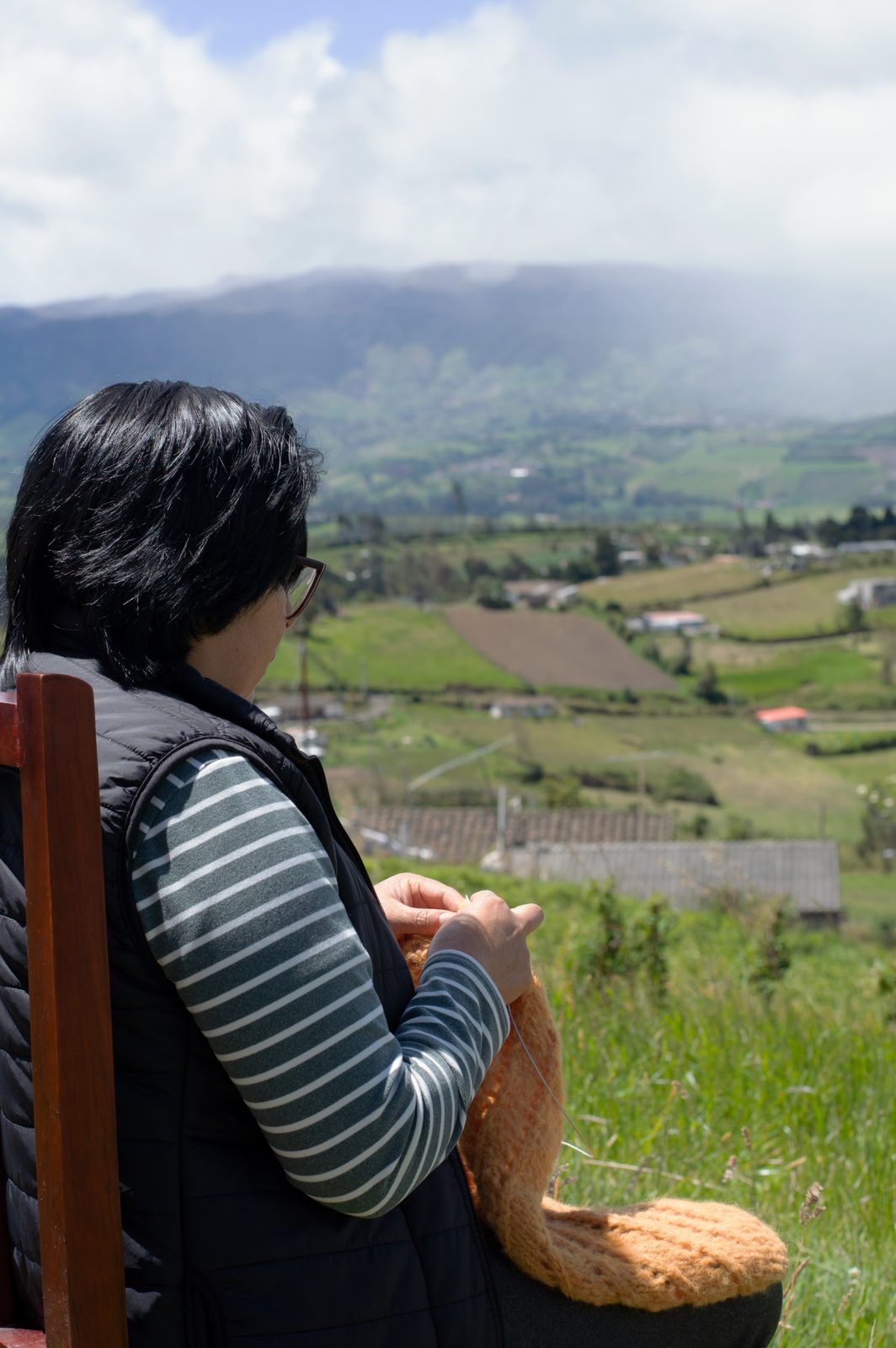 A Harrington artisan hand-knitting above the valley in Imbabura, Ecuador